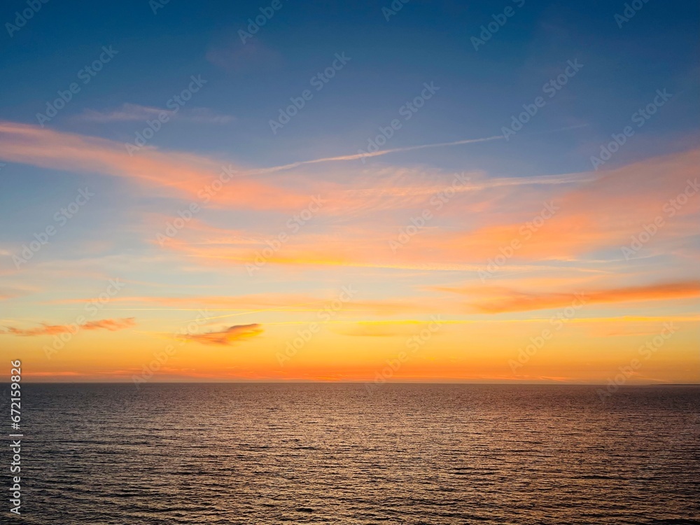 Beautiful colorful sky after the sunset at the sea coast, natural colors, sunset seascape background