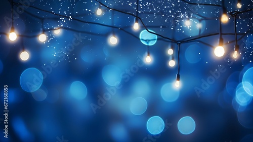 Holiday illumination: Christmas garland bokeh lights on dark blue background