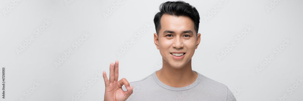 Portrait of young Asian man posing on white background Portrait of young Asian man posing on white background