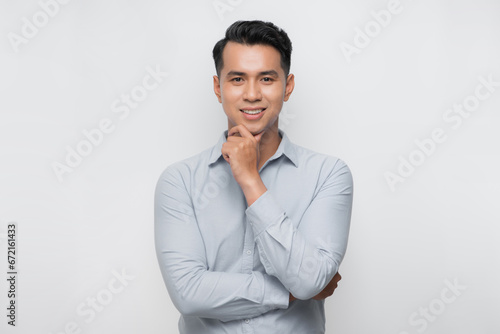 Close up portrait of smiling handsome guy in gray t-shirt isolated on white background