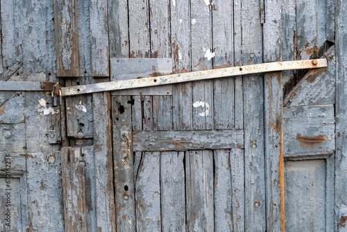 Old door with metal bolt and padlock