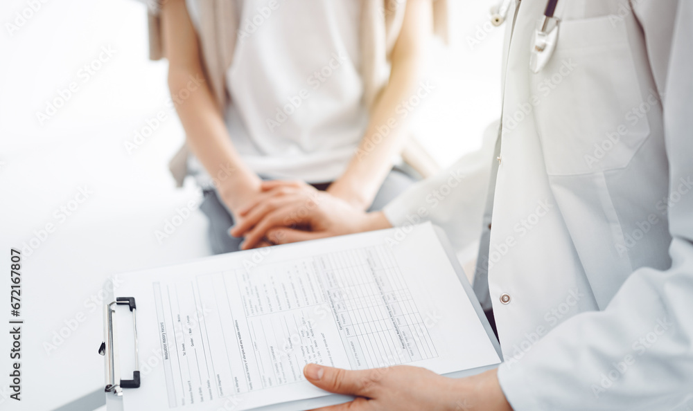 Doctor and child patient. The physician is holding clipboard and reassuring a boy. The concept of ideal health in medicine Doctor and child patient. The physician is holding clipboard and reassuring a boy. The concept of ideal health in medicine