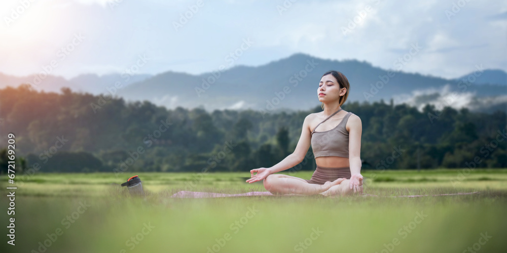 Asian woman on fitness mat, sporty lady practicing yoga at public park outdoor, stretching her body. Healthy active lifestyle