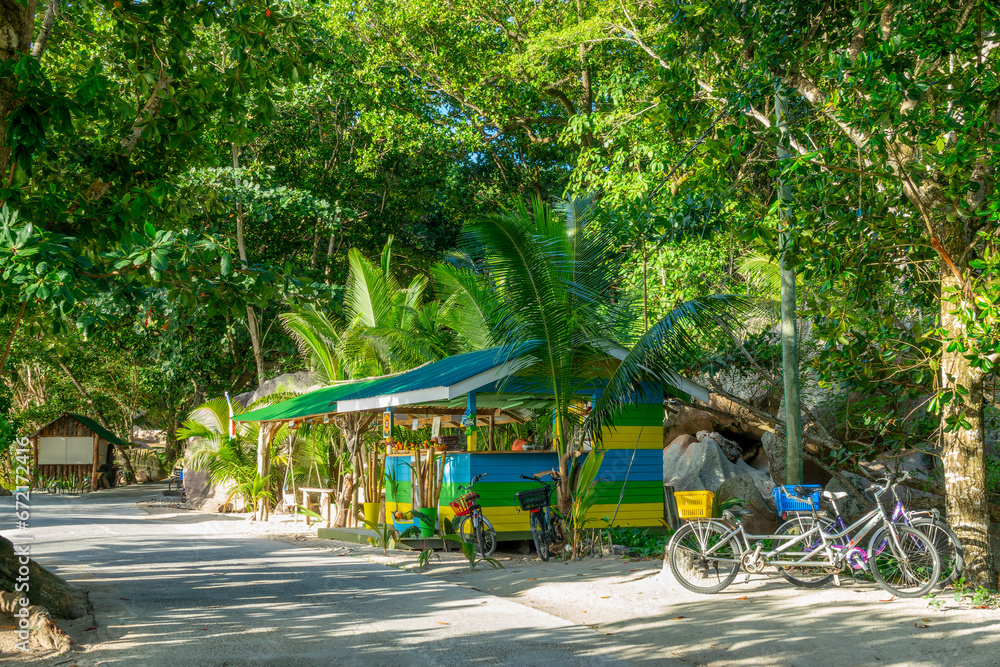 Bikes and beach bar on the road of La Digue island, Seychelles