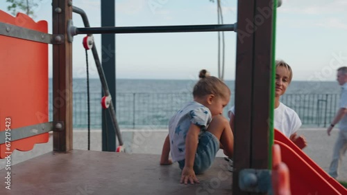 Wallpaper Mural Young mother supporting her son on the playground. Children playing outdoor, kids outside, summer holiday and vacation. High quality 4k footage Torontodigital.ca