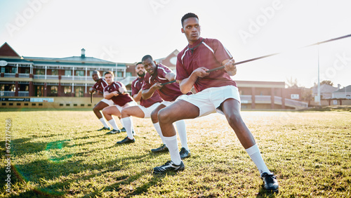 Sports, teamwork and tug of war, men at fitness training and practice for competition or game on field. Workout, collaboration and team pulling rope, working together in match for power and strength