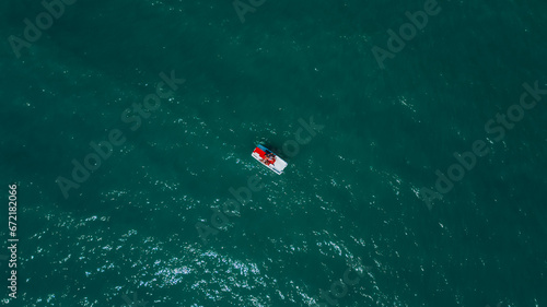 Drone photo pedalos in the water on a beautiful summer day. Drone photography. Summer vacation concept. Aerial view of an emerald and transparent Adriatic sea, Rimini, Italy