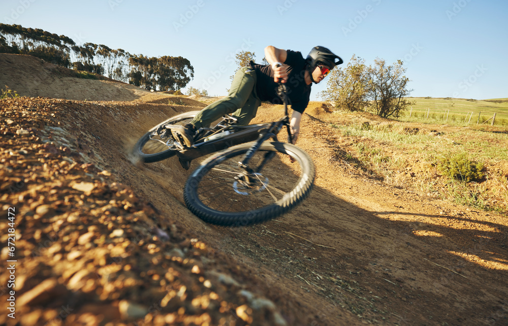 Obraz premium Cycling, mountain bike and man outdoor in nature for extreme sports, training or workout. Hill, focus and wellness of male athlete person with courage or bicycle stunt for off road travel adventure