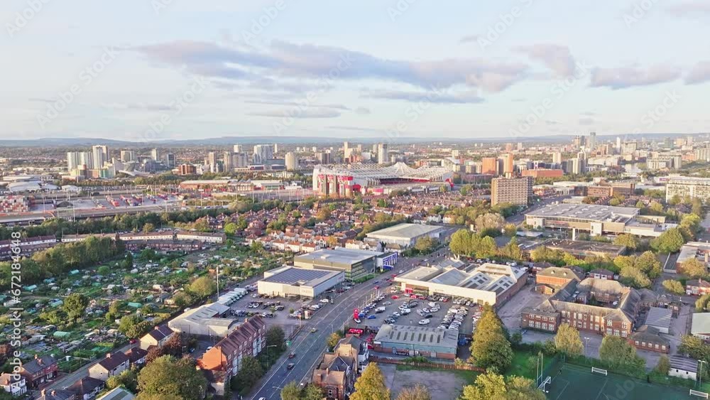 Aerial forward shot of Manchester United's Old Trafford football stadium, England. Cityscape of European cities. Aerial forward shot of Manchester United's Old Trafford football stadium, England. Cityscape of European cities.