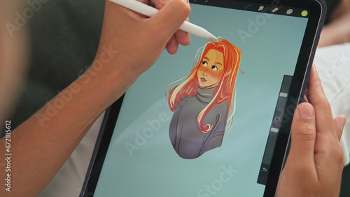 Digital artist draw pc tablet close up. Designer paint red head girl pic. Illustrator use ipad stylus pen. Pad user develop art skill. Person make work app. Hand hold color pencil. Woman game logotype photo