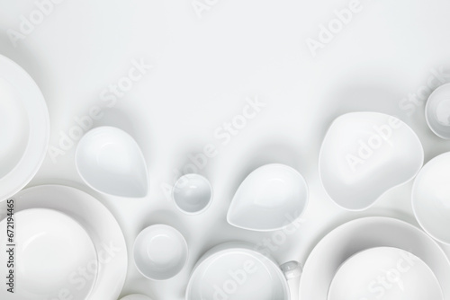 Set of different pure white dishes for home or restaurant on white background. Top view  flat lay  copy space
