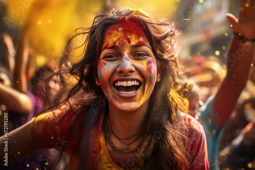 young woman smiling face closeup at holi festival in India covered with colorful paint powder