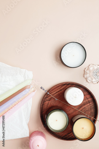 Set of various scented candles with branding mock up on a beige background. Top view, copy space, flat lay © matucha12