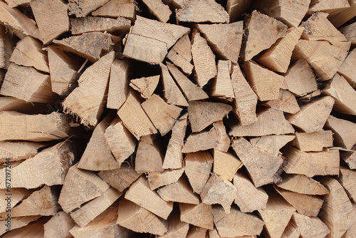 Stack of firewood. Chopped logs background. Woodpile background. Stacked wood. Wooden texture. Logging storage. Harwood background. Pile of firewood. Preparation for winter.