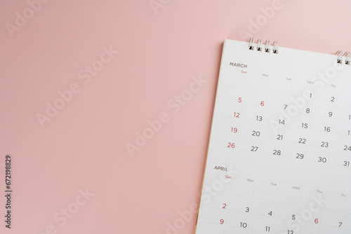 close up of calendar on the pink table background, planning for business meeting or travel planning concept