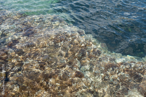 Fototapeta Naklejka Na Ścianę i Meble -  clear teal blue sea water on the Mediterranean coast abstract beach background