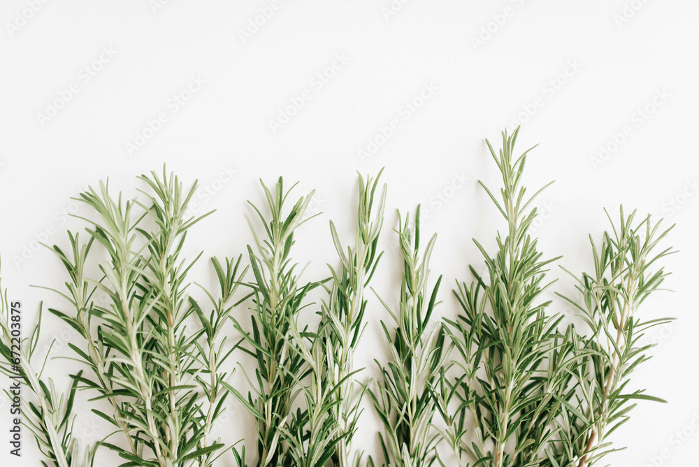 Naklejka premium Sprigs of fresh rosemary on a white background. Fragrant rosemary top view.