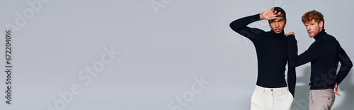 handsome diverse male models posing on gray backdrop, hand near face, hand on shoulder, banner