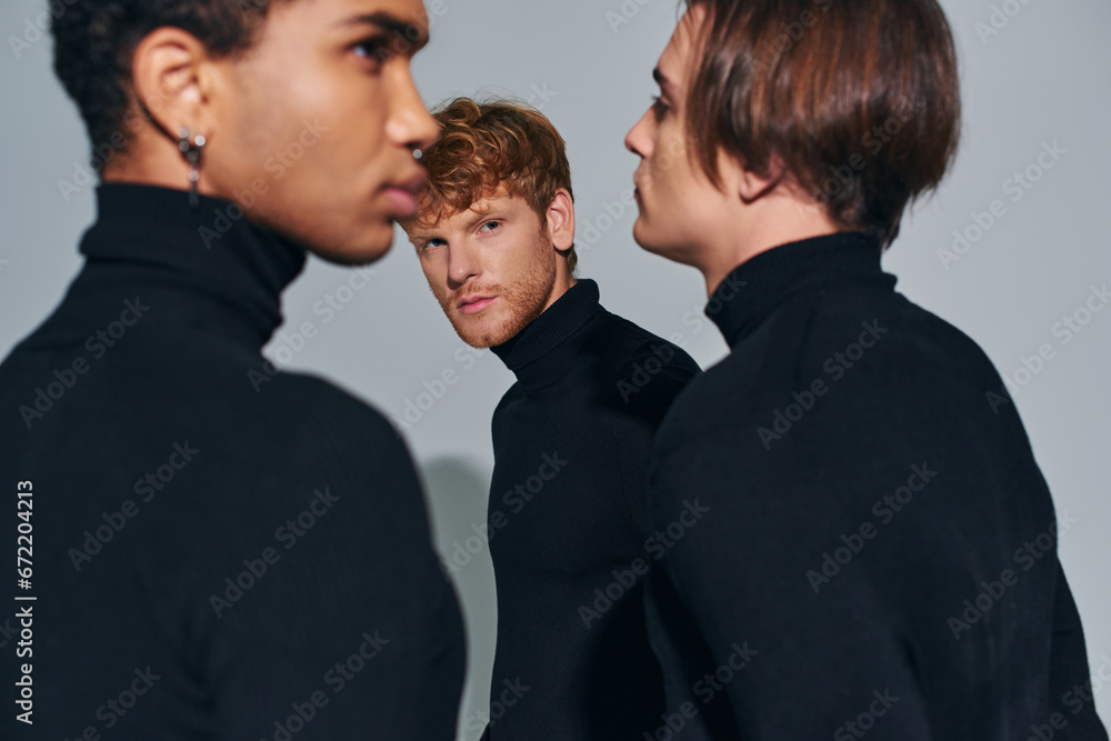 focus on bearded man standing near blurred diverse friends in elegant turtlenecks, fashion concept focus on bearded man standing near blurred diverse friends in elegant turtlenecks, fashion concept