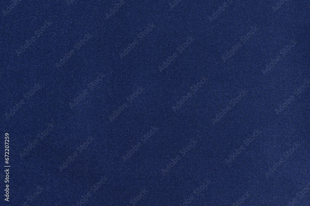 texture of twill fabric with blue glitter made of polyester. The concept of fabric for sewing. Background for your design