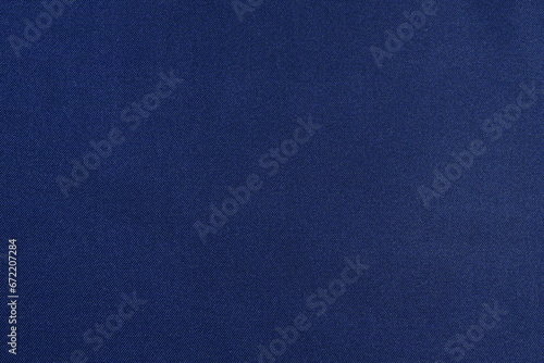 Close-up texture of twill and polyester fabric of blue color. The concept of fabric for sewing. Image for your design