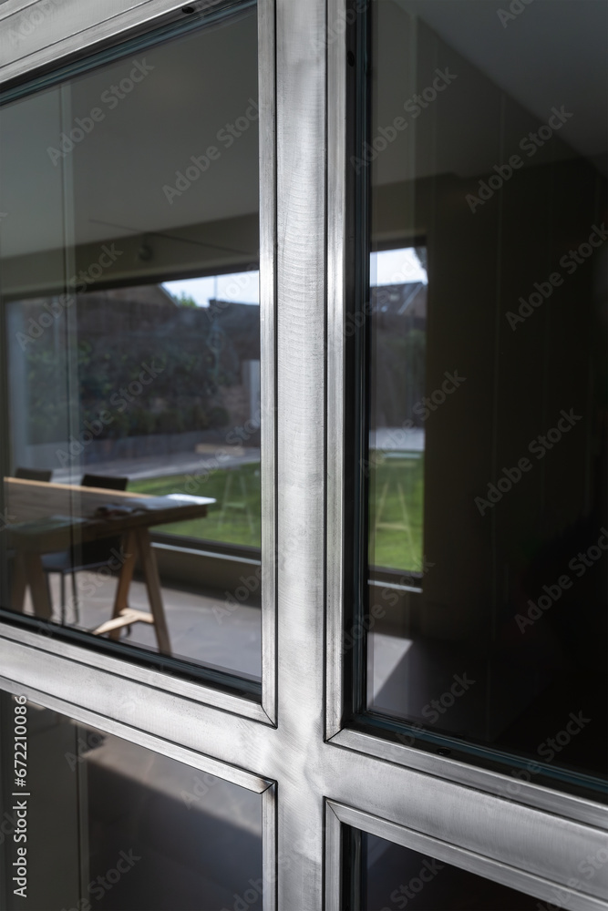 Close-up detail of sliding metal door with glass. Steel door. Design concept and durability