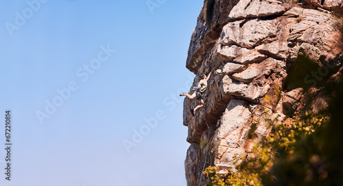 Rock climbing, fitness and space with man on mountains for sports, banner and adventure. Nature, exercise and travel with person training on cliff for rope, challenge and performance mockup on sky