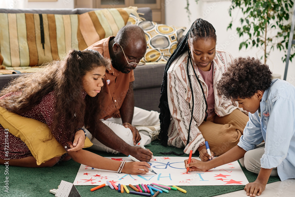 Fototapeta premium Mother, father, daughter and son creating I have a dream placard for Martin Luther King Jr day
