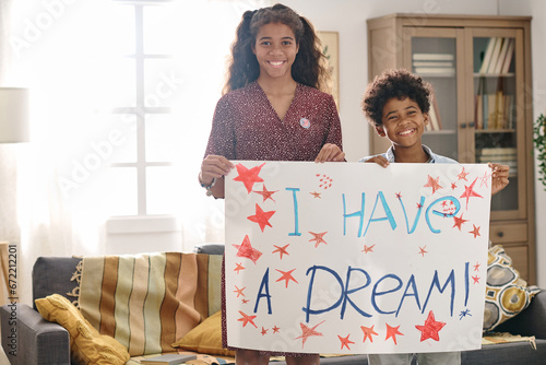 Portrait of smiling brother and sister holding I have a dream placard created for Martin Luther King Jr day photo