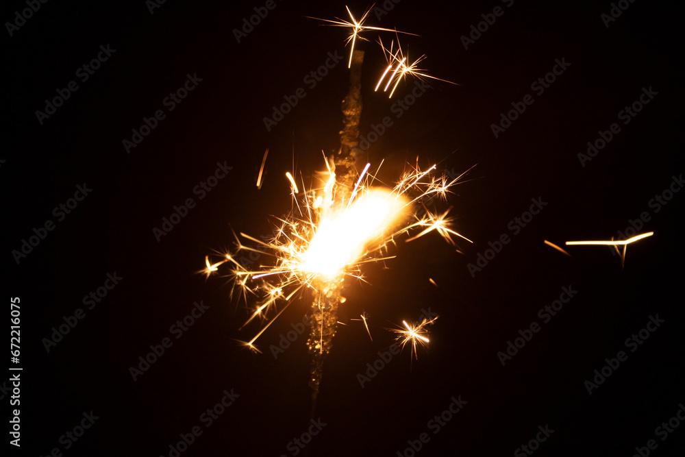 Burning sparkler on black background. New year and Christmas party