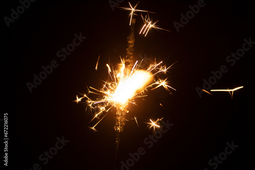 Burning sparkler on black background. New year and Christmas party