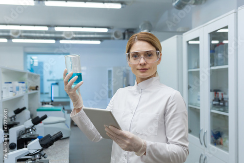 Wallpaper Mural Portrait of serious confident female research lab worker looking at camera, working with tablet computer indoors with microscopes. Torontodigital.ca