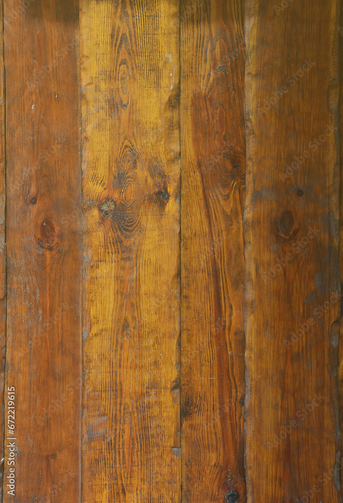 Texture of the old wooden wall from a number of scratched planks that are varnished
