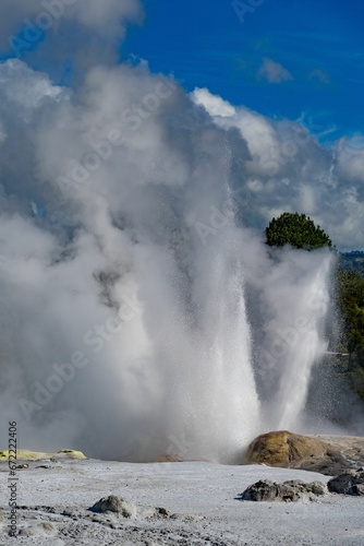Geyser erupts and disperses a powerful stream of water into the air.