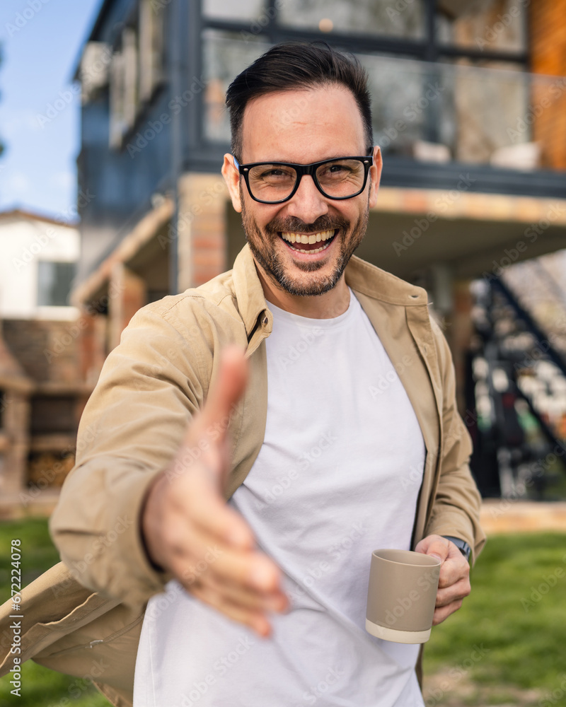 Happy Homeowner Man with Cup of Tea Stand in Front of Modern House Happy Homeowner Man with Cup of Tea Stand in Front of Modern House