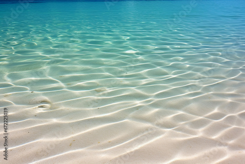 Rippled sand under crystal-clear ocean water