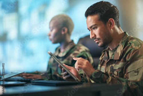 Asian man, army and tablet in surveillance, control room or checking data for military intelligence. Male person, security or soldier working on technology for online dispatch or networking at base photo
