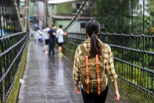 Woman walk the suspension bridge in Shihfen old village in Taiwan