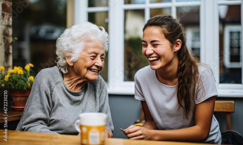 Bubbly Carer Shares Laughs with Spirited Elderly Woman in Kitchen