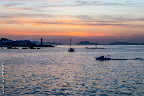 Sunset in the Vigo estuary. Photographed from the Bouzas neighborhood. You can see the Museum of the Sea and a sailboat at anchor. Galicia, Spain. photo
