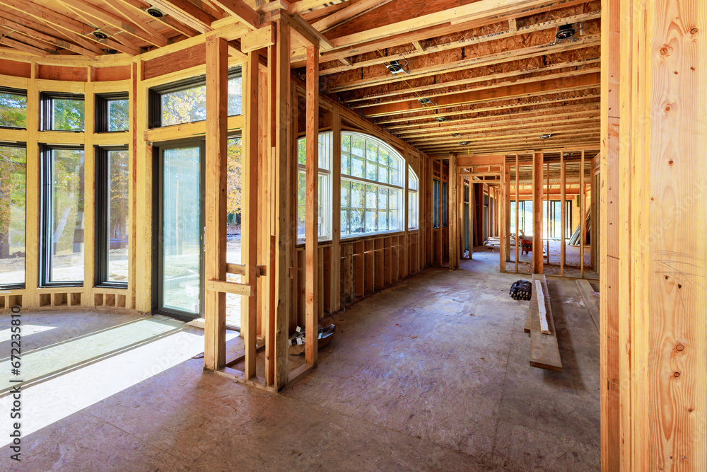 Newly constructed home improvement project in process of framing beams for wooden house in construction area Newly constructed home improvement project in process of framing beams for wooden house in construction area