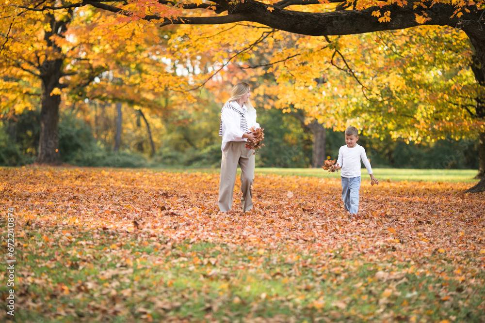 Mothers day, love family. Family on autumn walk in nature outdoors. Mother and child with hugging tenderness Mothers day, love family. Family on autumn walk in nature outdoors. Mother and child with hugging tenderness