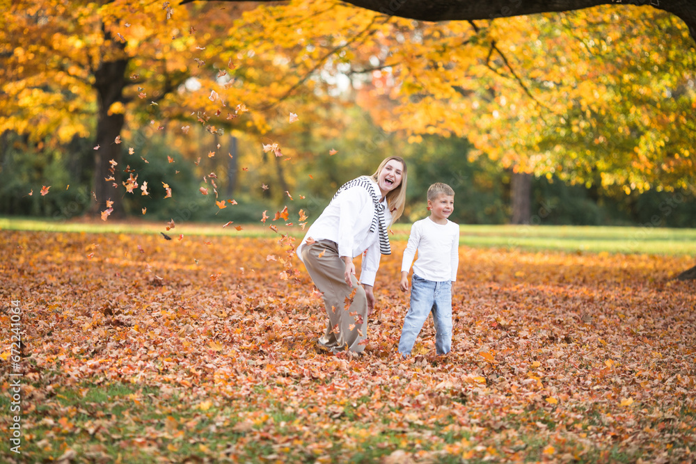 Mothers day, love family. Family on autumn walk in nature outdoors. Mother and child with hugging tenderness Mothers day, love family. Family on autumn walk in nature outdoors. Mother and child with hugging tenderness