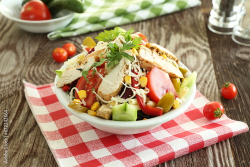Healthy salad with roasted chicken, pepper, tomato and cheese 