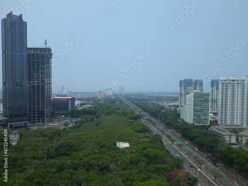 High angle view jakarta indonesia city scape with tower building, highway street and green public park