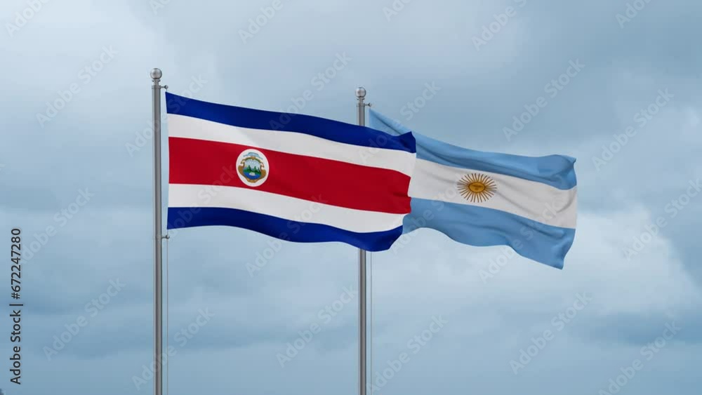 Argentina flag and Costa Rico flag waving together on cloudy sky, endless seamless loop, two country relations concept Argentina flag and Costa Rico flag waving together on cloudy sky, endless seamless loop, two country relations concept