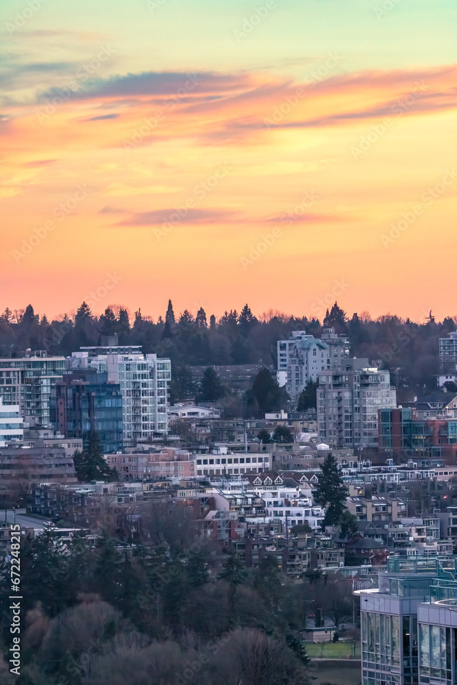 Colorful soft warm light over an urban cityscape with apartment buildings and tall high rises - Vancouver British Columbia
