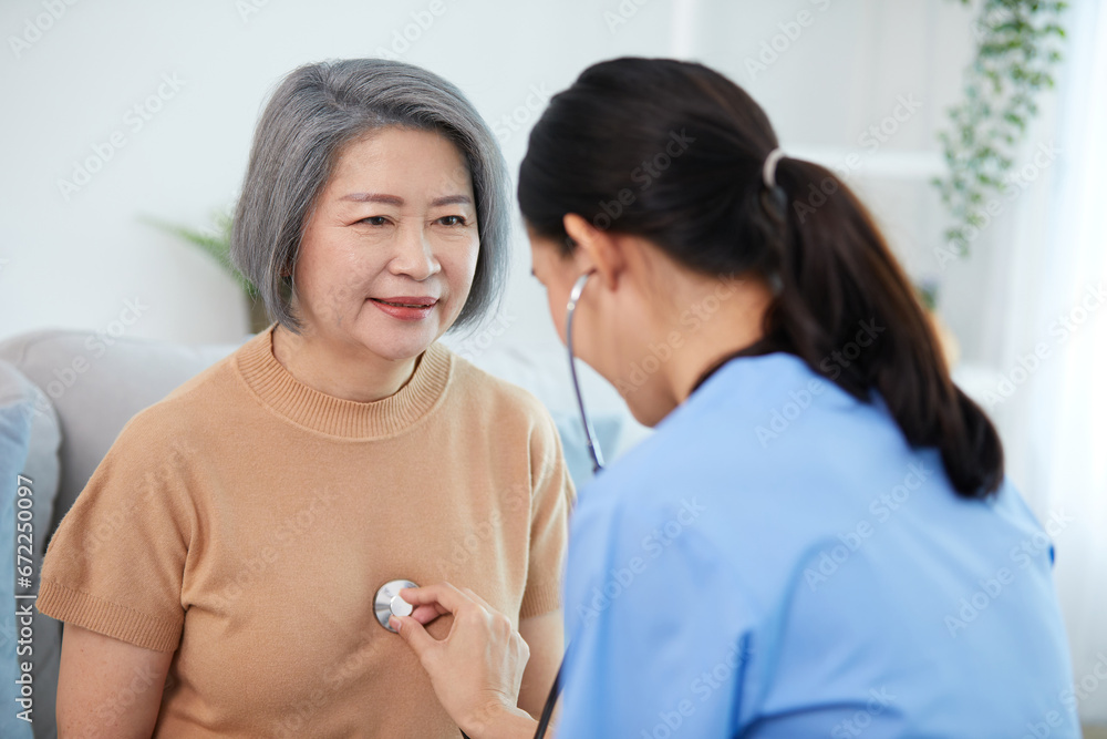 nurse or caregiver using stethoscope to examine senior woman at home nurse or caregiver using stethoscope to examine senior woman at home