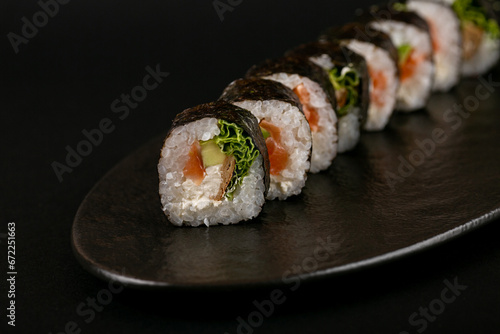 sushi rolls beautifully laid out on the table by Italians, serving sushi to a client, beautiful photos of sushi for advertising