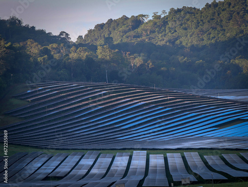panoramic view of a solar panel station at hillside in early morning